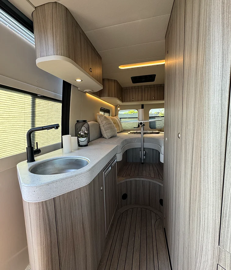 Kitchen galley of Innova Roadtrip 595L with Dometic fridge and induction cooktop
